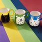 Hand painted black mug with cat illustration
