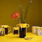 Handmade yellow vase with a black cat illustration